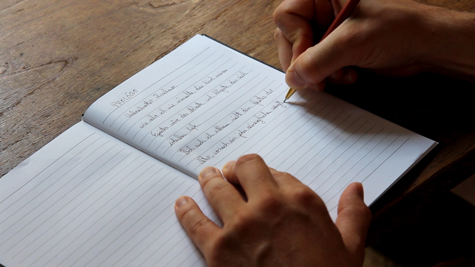 A hand writing the prologue into the diary